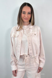 woman wearing an opened light pink denim jacket 