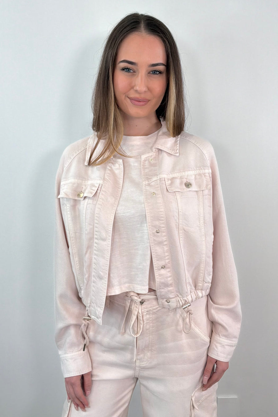 woman wearing an opened light pink denim jacket 
