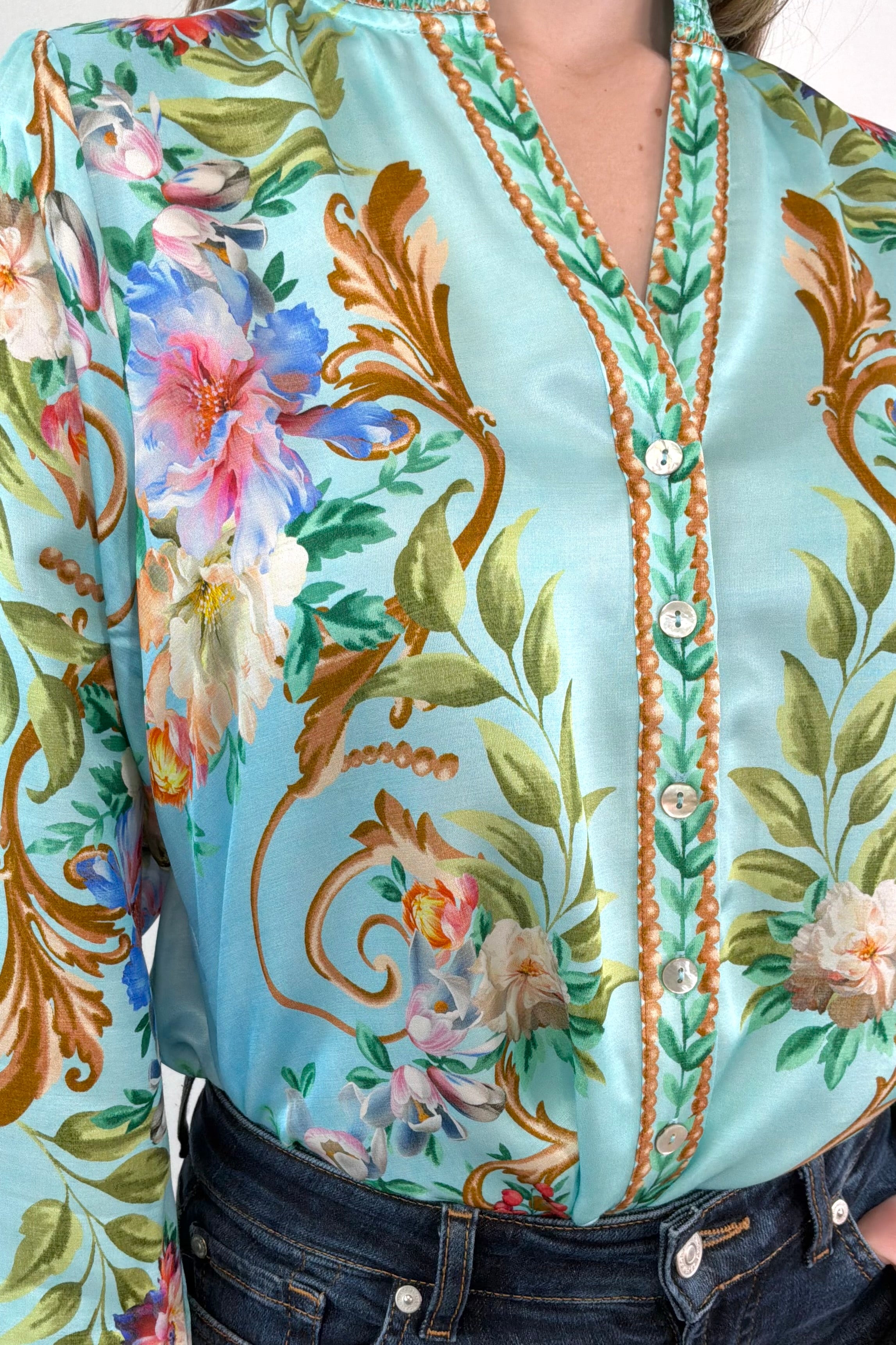 Close-up of a teal regency printed button down shirt