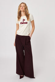 Front view of woman wearing a knitted tee shirt with text on it