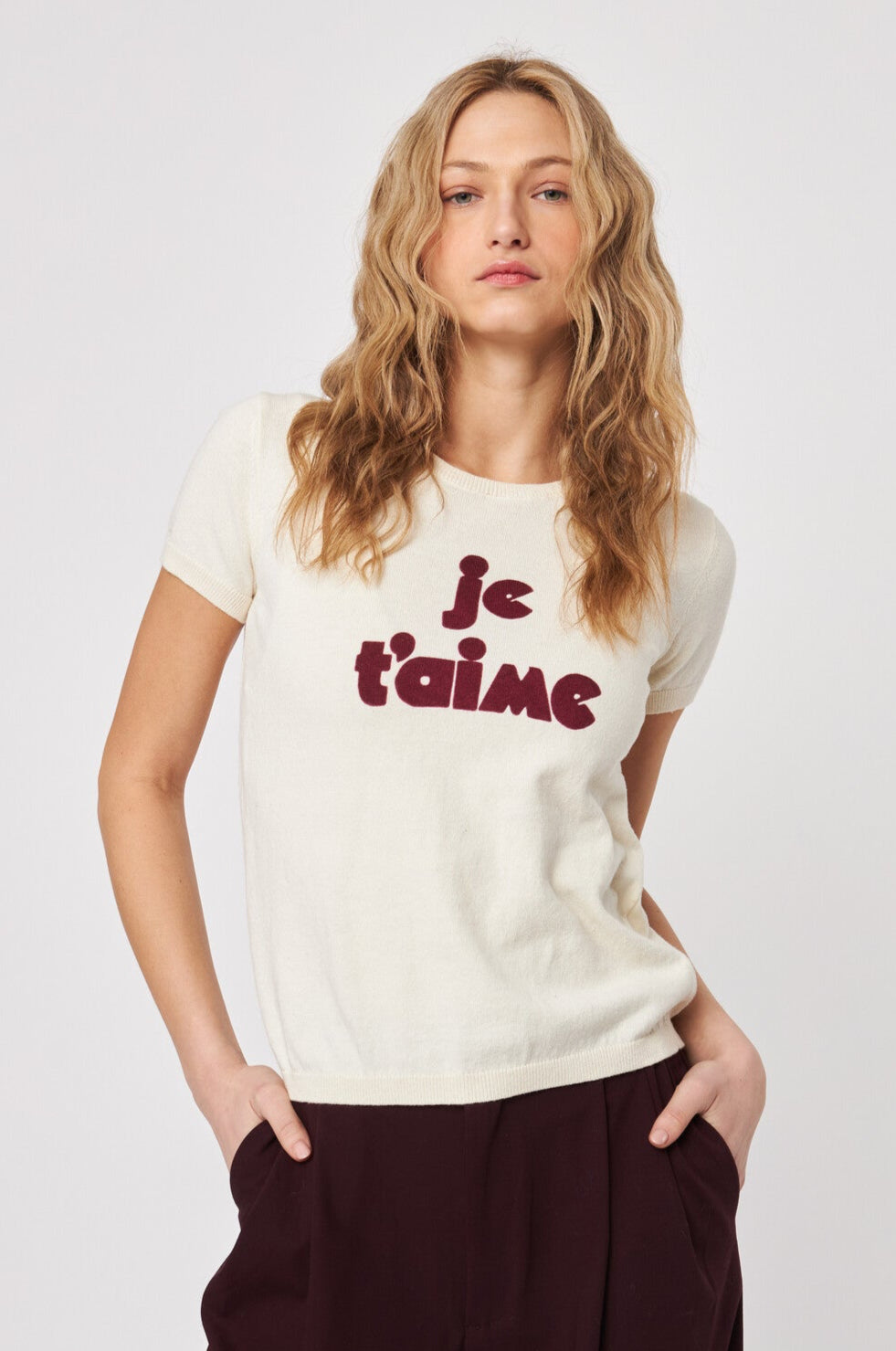 Front View of woman wearing a knitted tee shirt with text on it