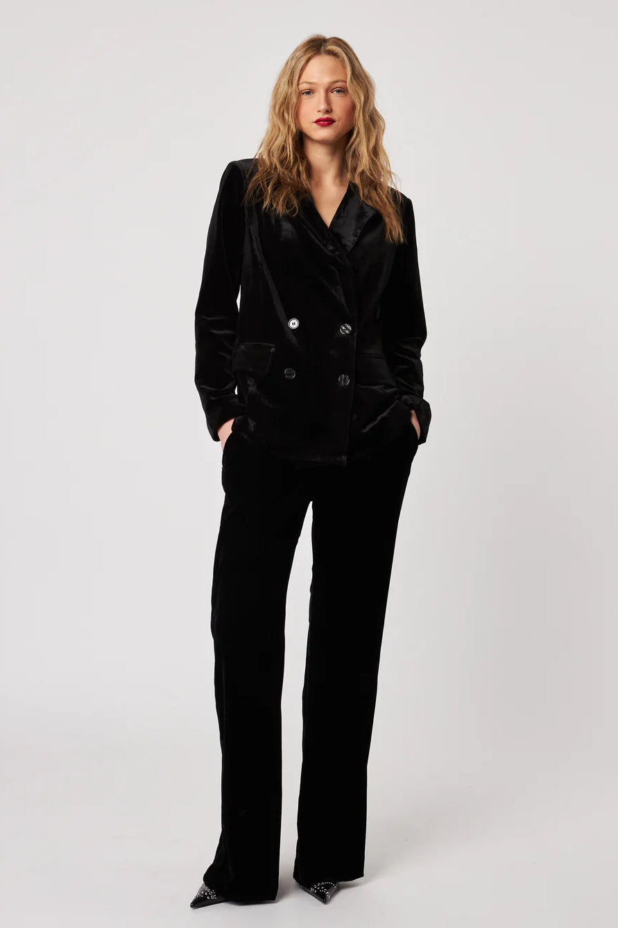 Woman wearing a black suit on a white background