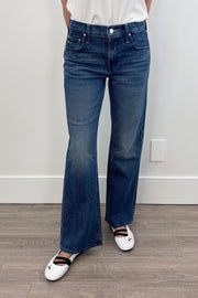 Woman wearing a dark indigo washed flared denim