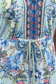 Women wearing blue floral patterned dress with scrunch tie around waist