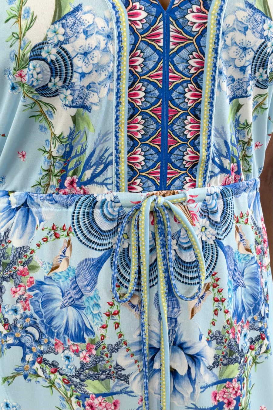 Women wearing blue floral patterned dress with scrunch tie around waist