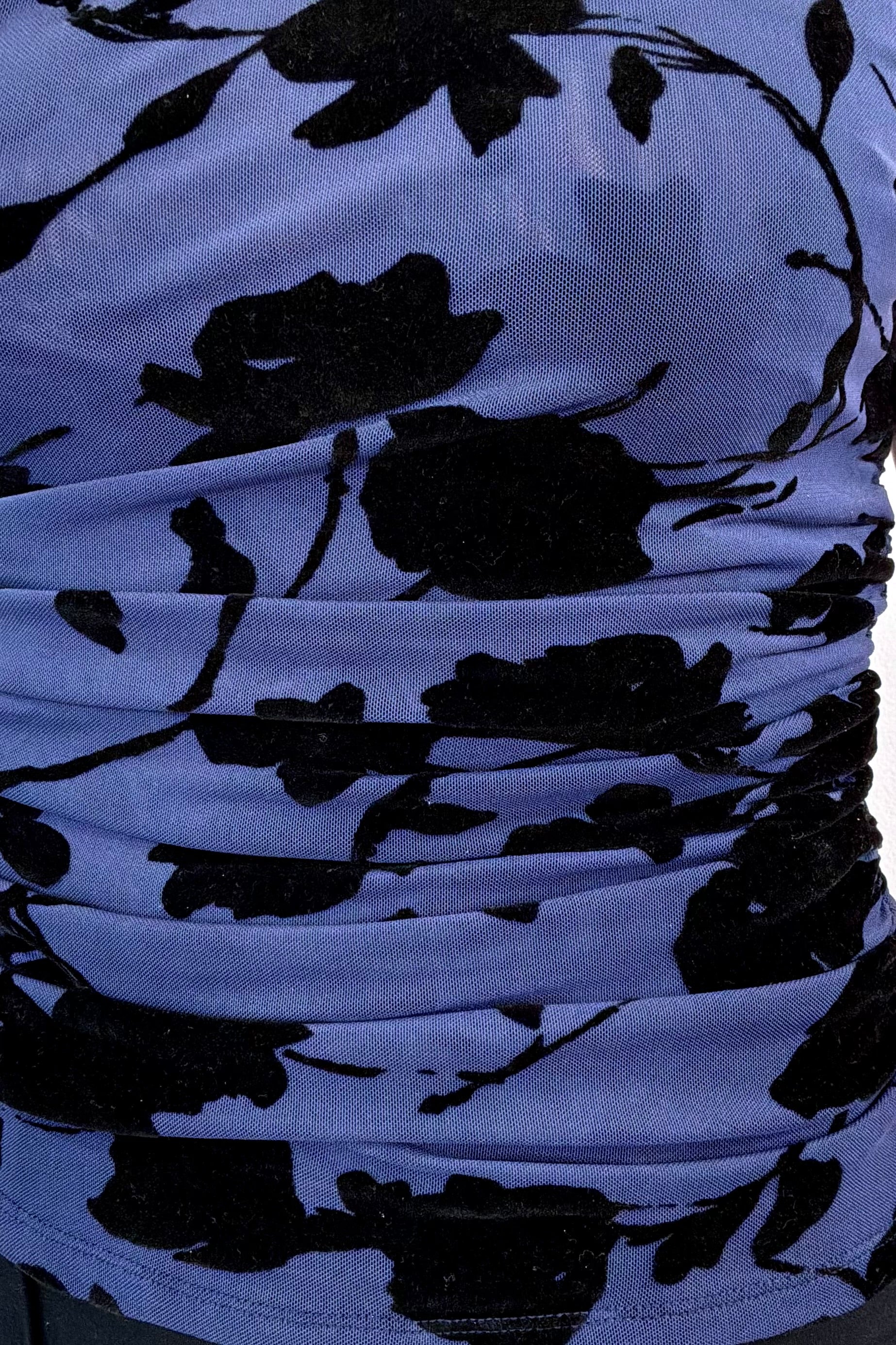 close-up of a sleeveless navy mesh top with black floral pattern 