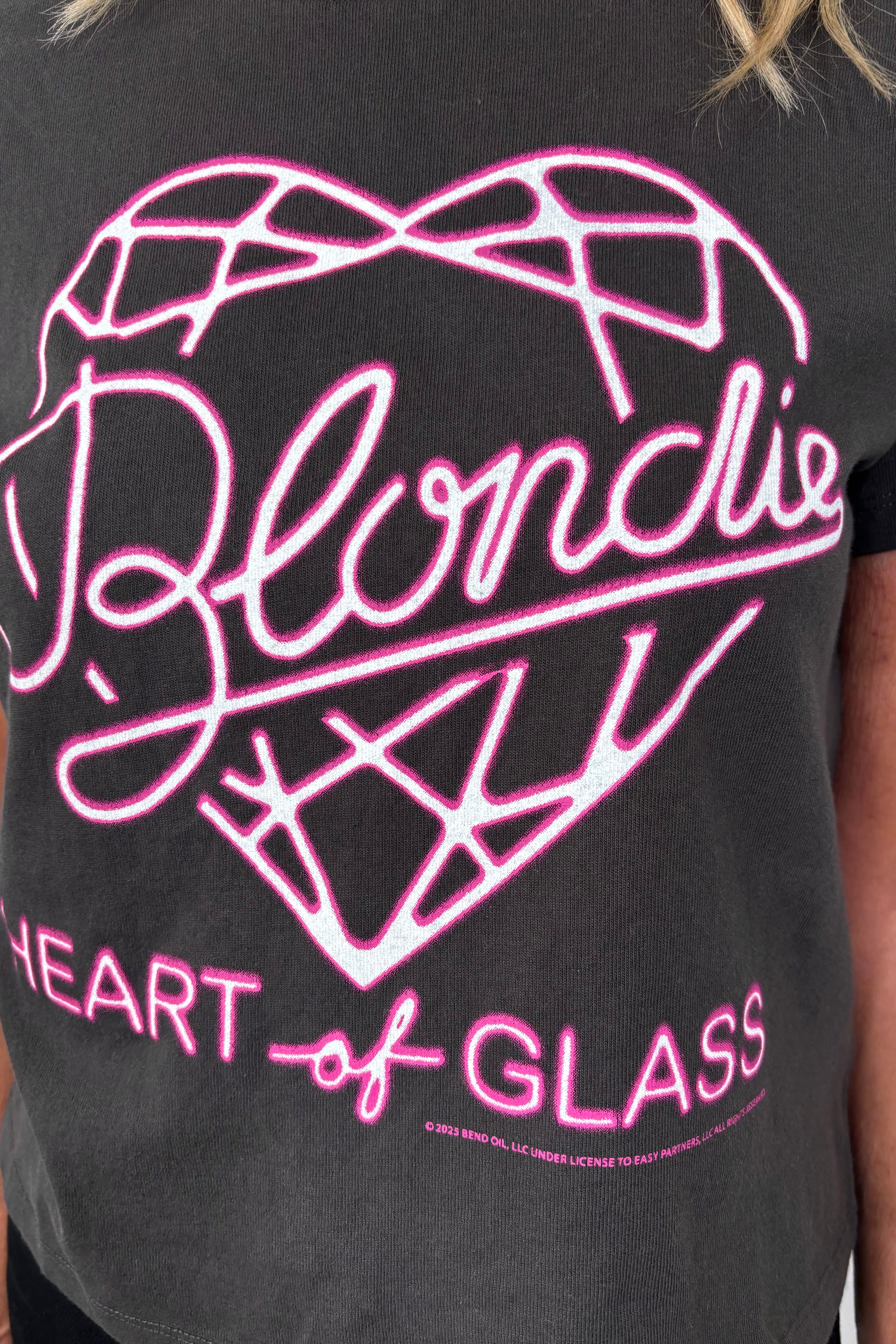Close-up of a black t-shirt with pink graphic design