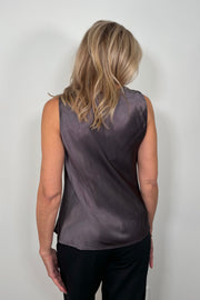 Back view of woman wearing a deep metallic gray satin tank top with a silver metal detail