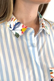 close- up of a white and blue striped dress with a silk floral patterns