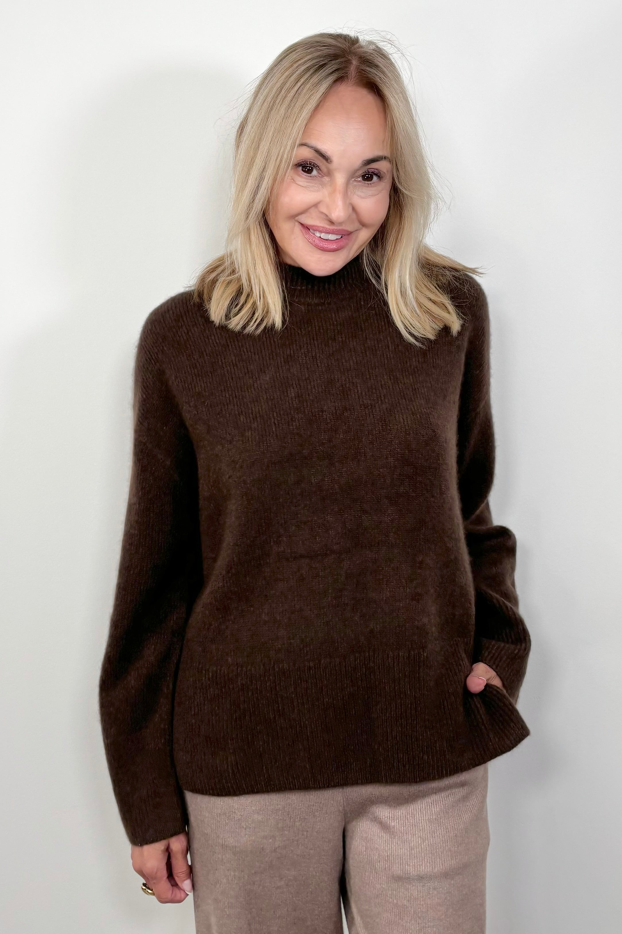 Front view of woman wearing an oversized cashmere brown sweater