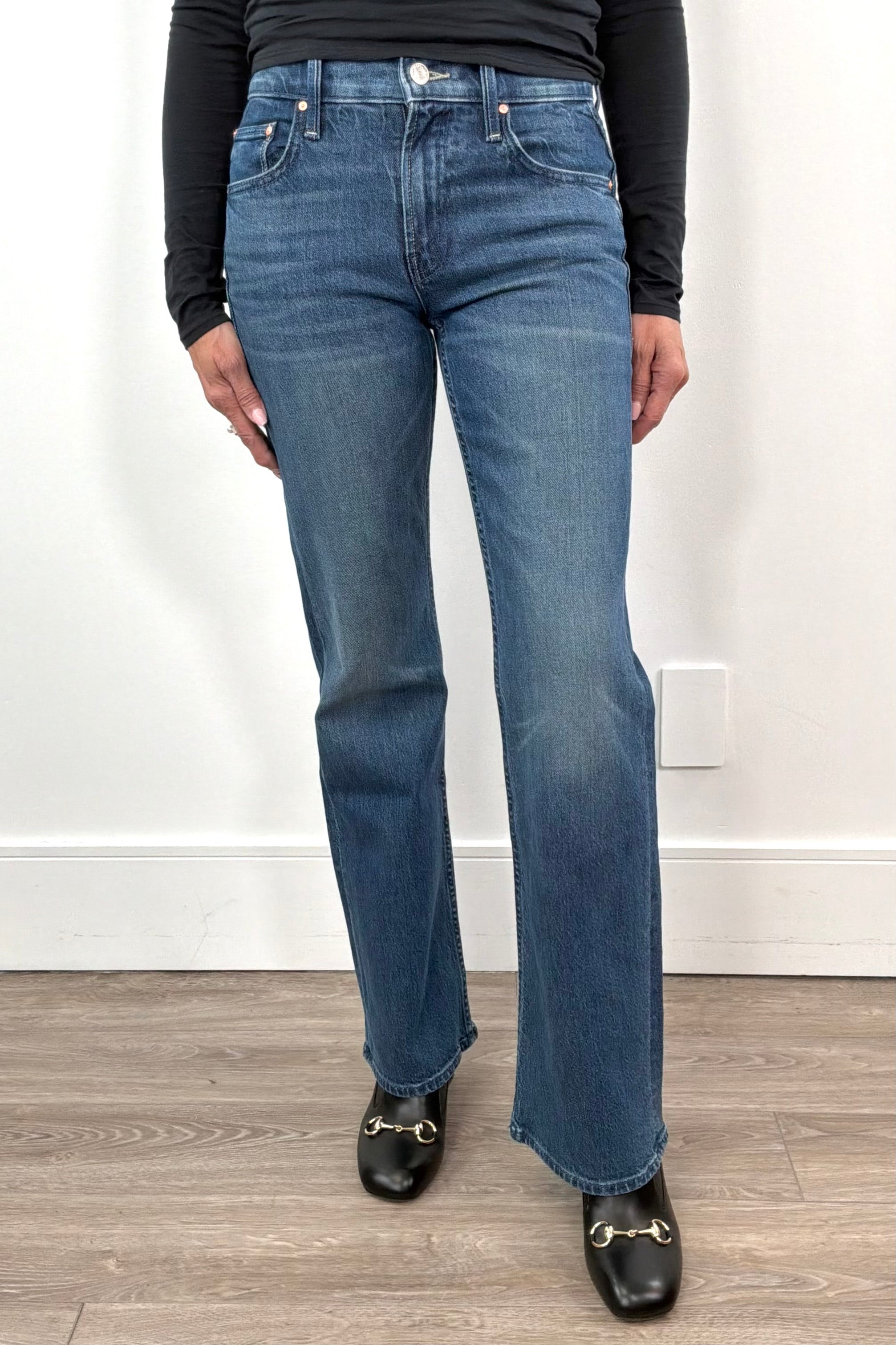 woman wearing straight leg boot cut blue jeans