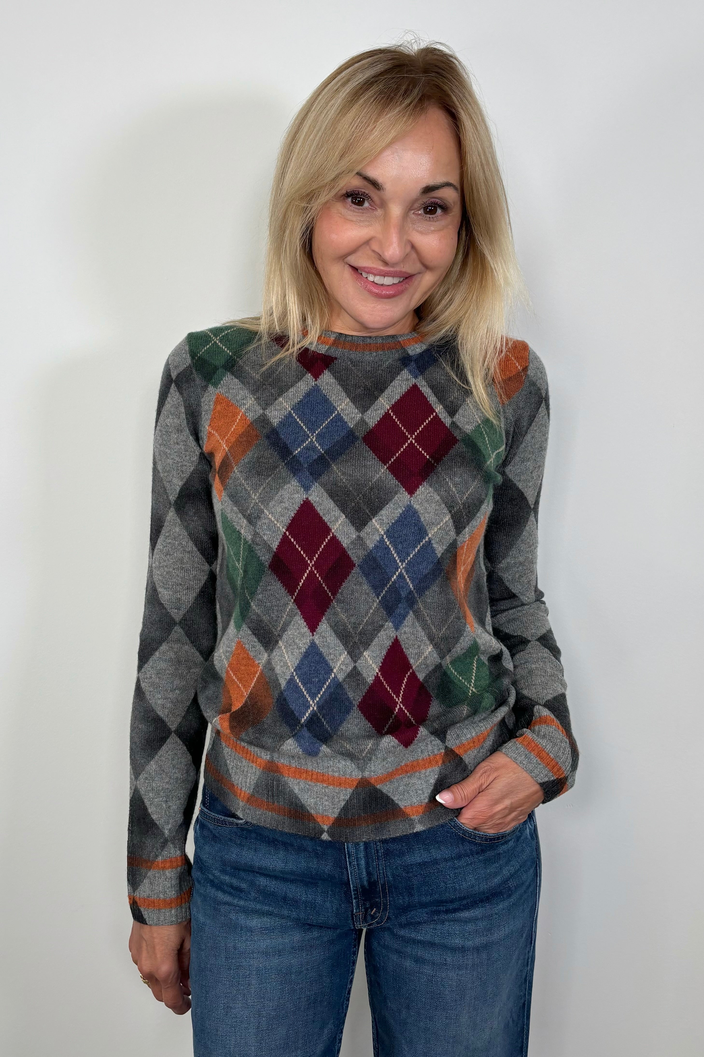 Front facing woman wearing a 100% cashmere Argyle long sleeve sweater
