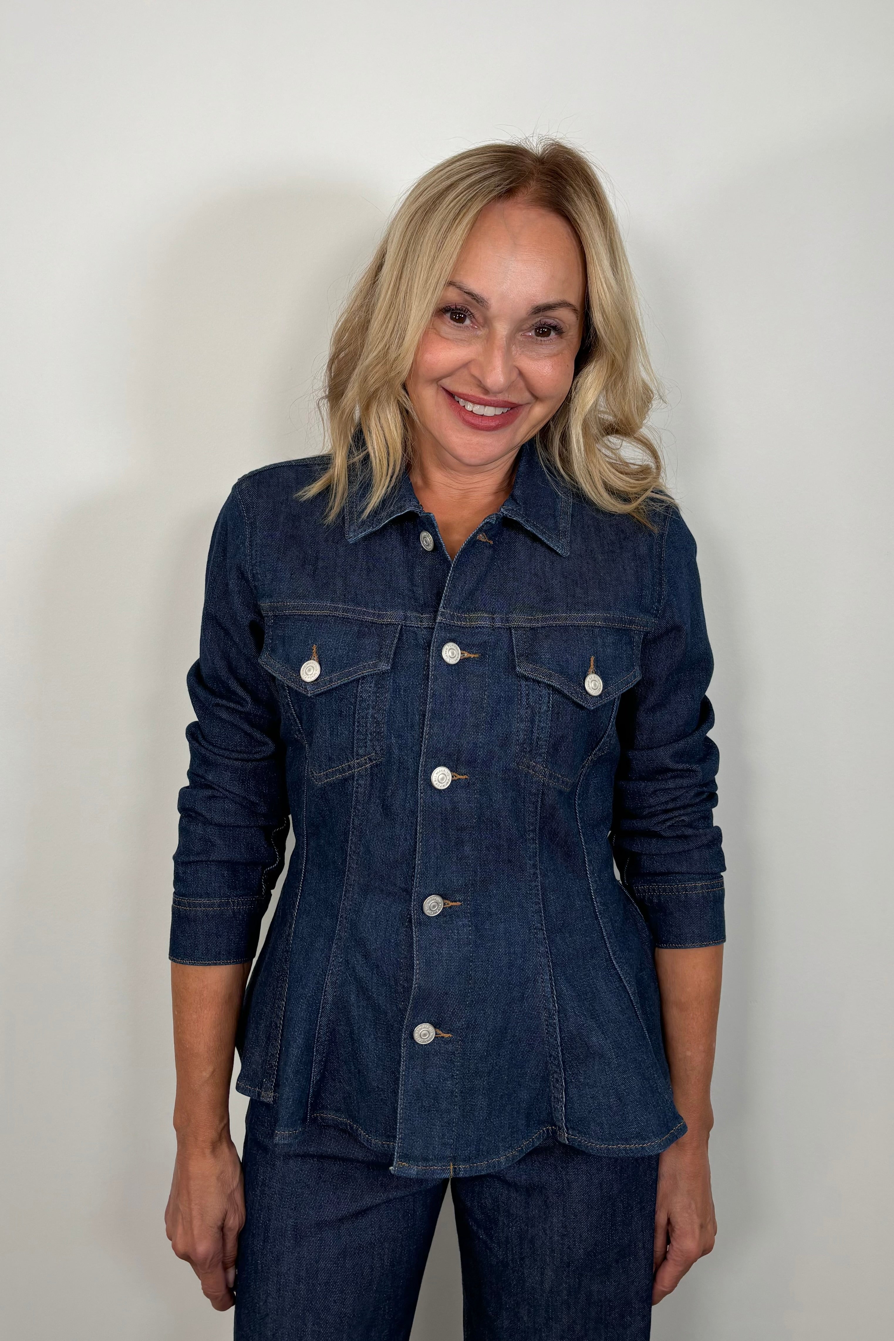 Front view of woman wearing a fitted denim jacket