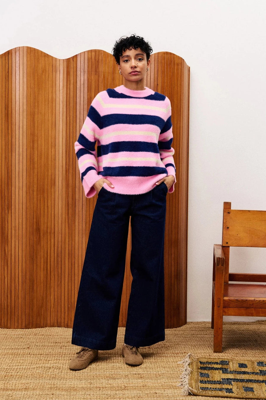 woman wearing pink blue and yellow striped pullover sweater 