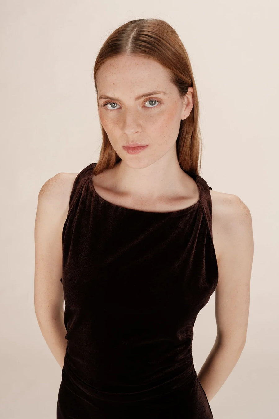 close-up of the neckline of a brown velvet dress