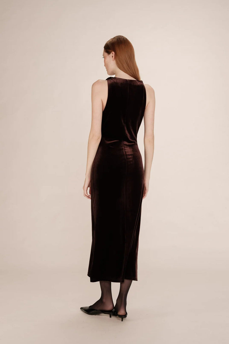 back of a woman wearing a brown velvet dress