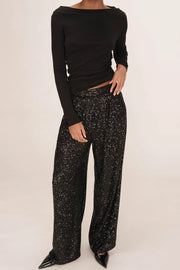 woman wearing black sequin wide leg pants