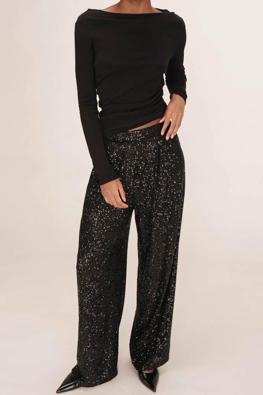 woman wearing black sequin wide leg pants