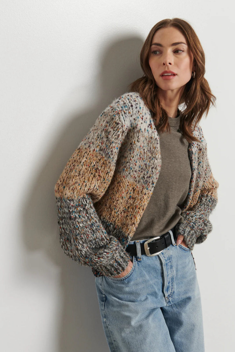 woman wearing a light gray, beige and dark gray knitted cardigan