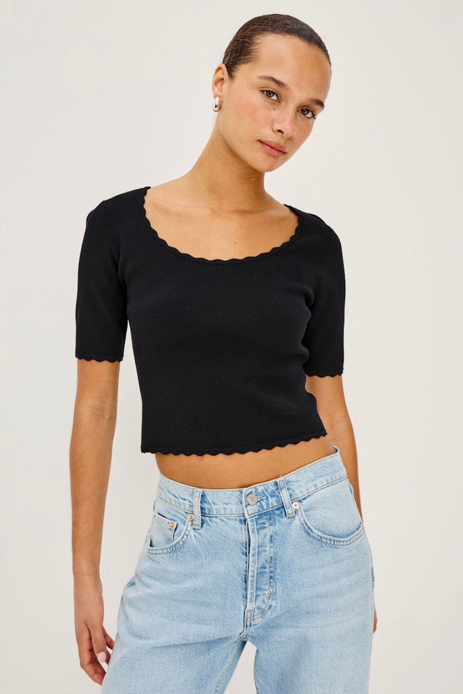 Woman wearing a short sleeve crop top in black