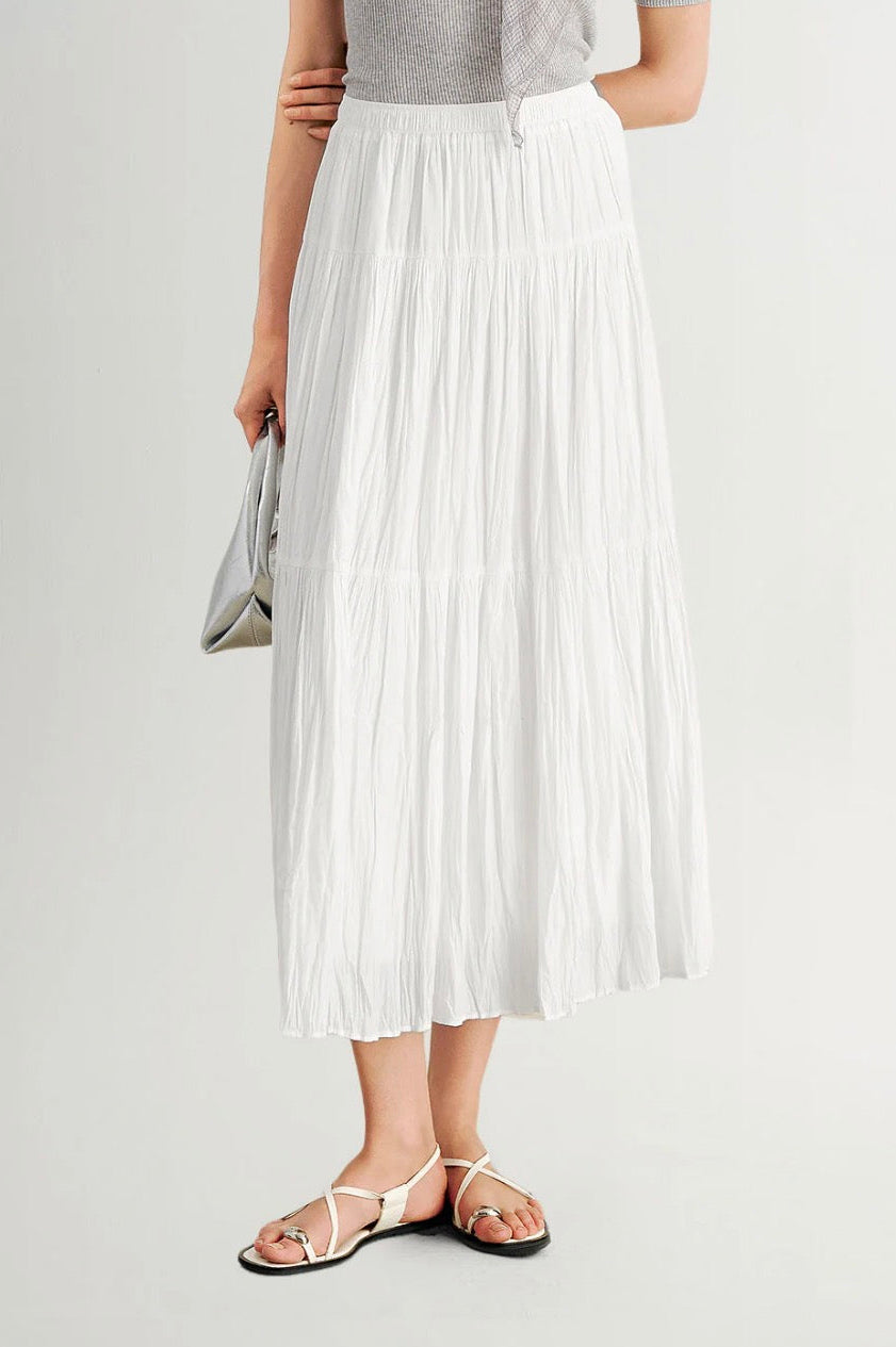 Woman wearing a pleated white skirt