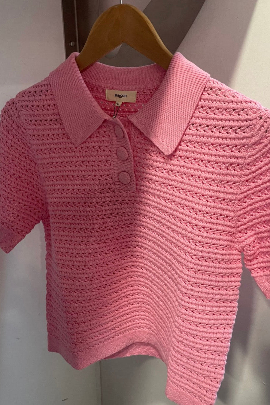 Light pink colored knit polo