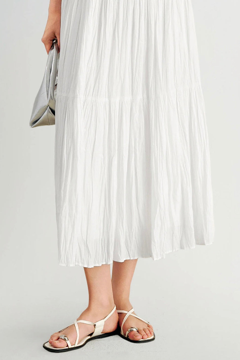 Close up of woman wearing a pleated white skirt