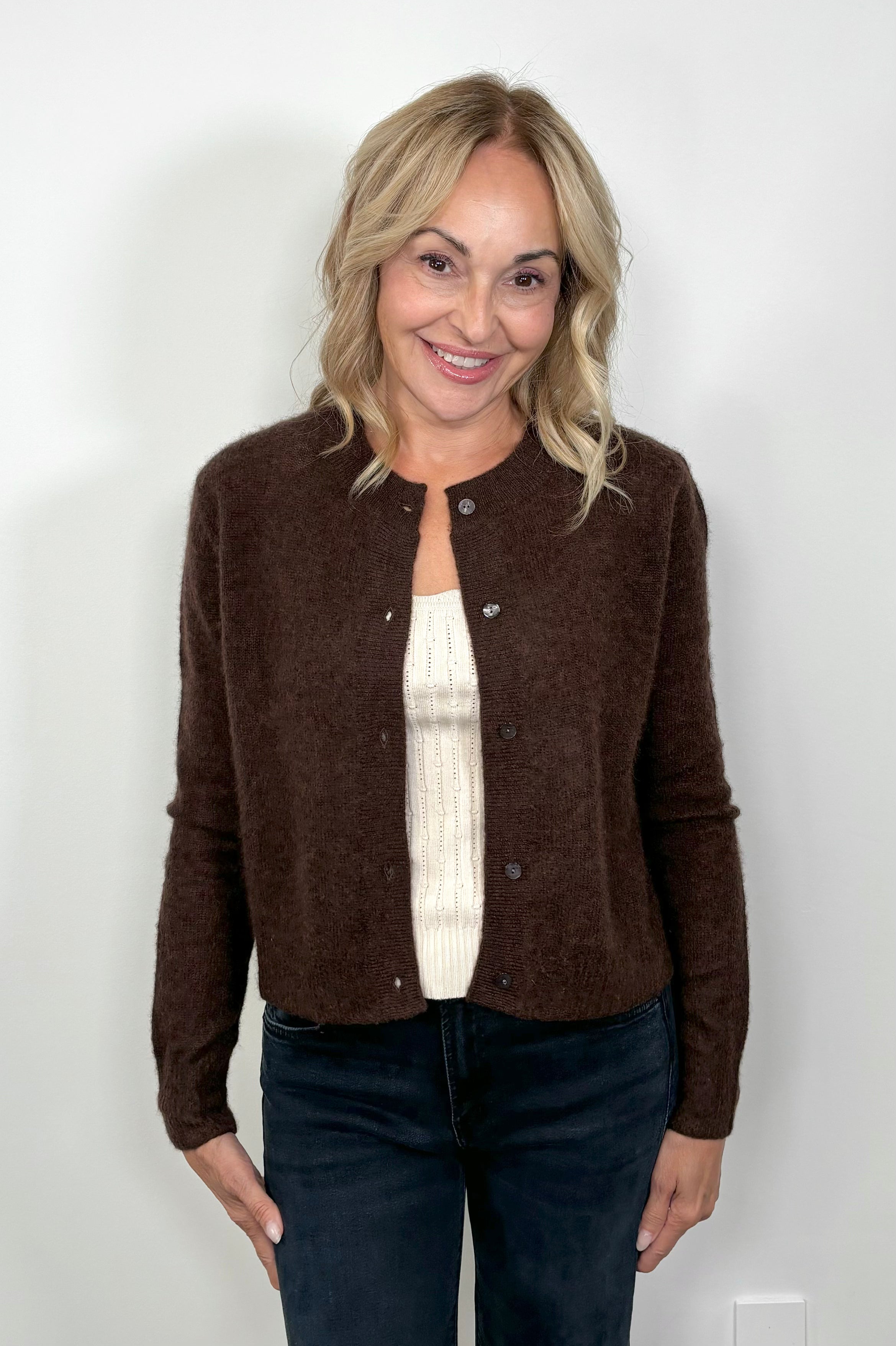 Front facing woman wearing a brown cashmere and silk blend cardigan open.