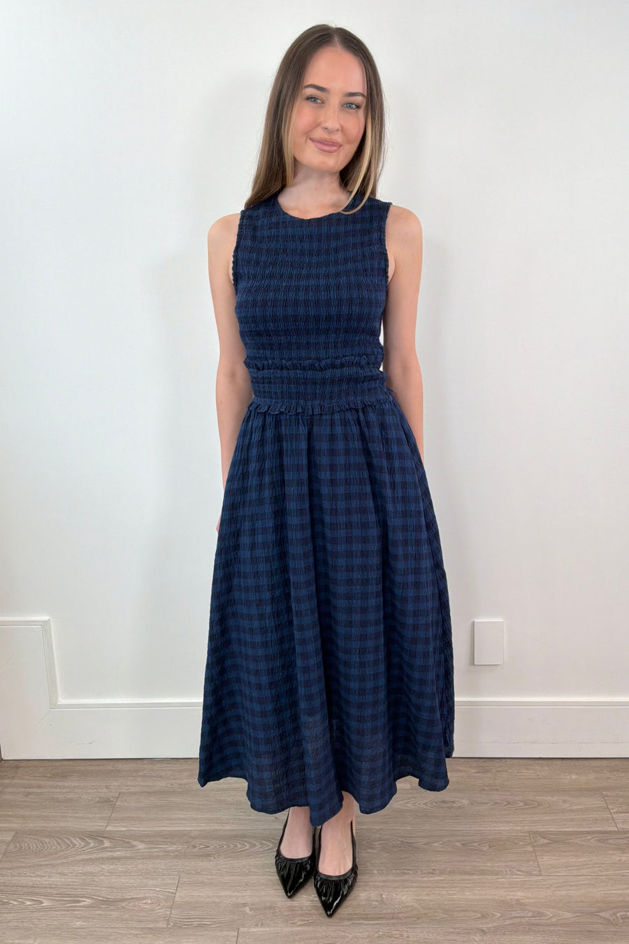 woman wearing a navy checkered midi dress 