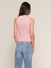 Back view of Woman wearing a ballet pink knit tank top with embroidered floral print around the neckline