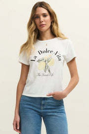 Woman wearing a white short sleeve graphic tee with the words "La Dolce Vita The Sweet Life" on the front and a picture of lemons, front view