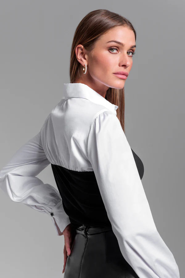 woman wearing a combo black franny on a white poplin shirt 