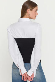 woman wearing a combo black franny on a white poplin shirt 