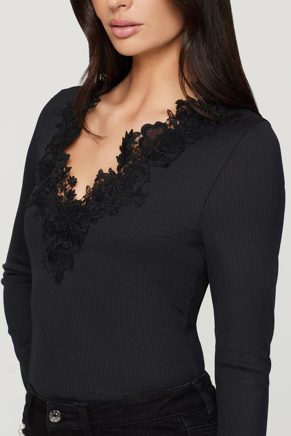 close-up of a black long-sleeve top with lace details in the v-neck