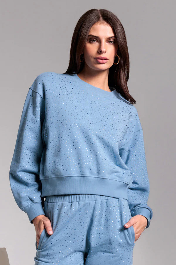 woman wearing a cotton crystal embellished sweatshirt