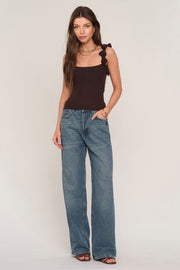 women wearing brown knit tank top with floral straps. 