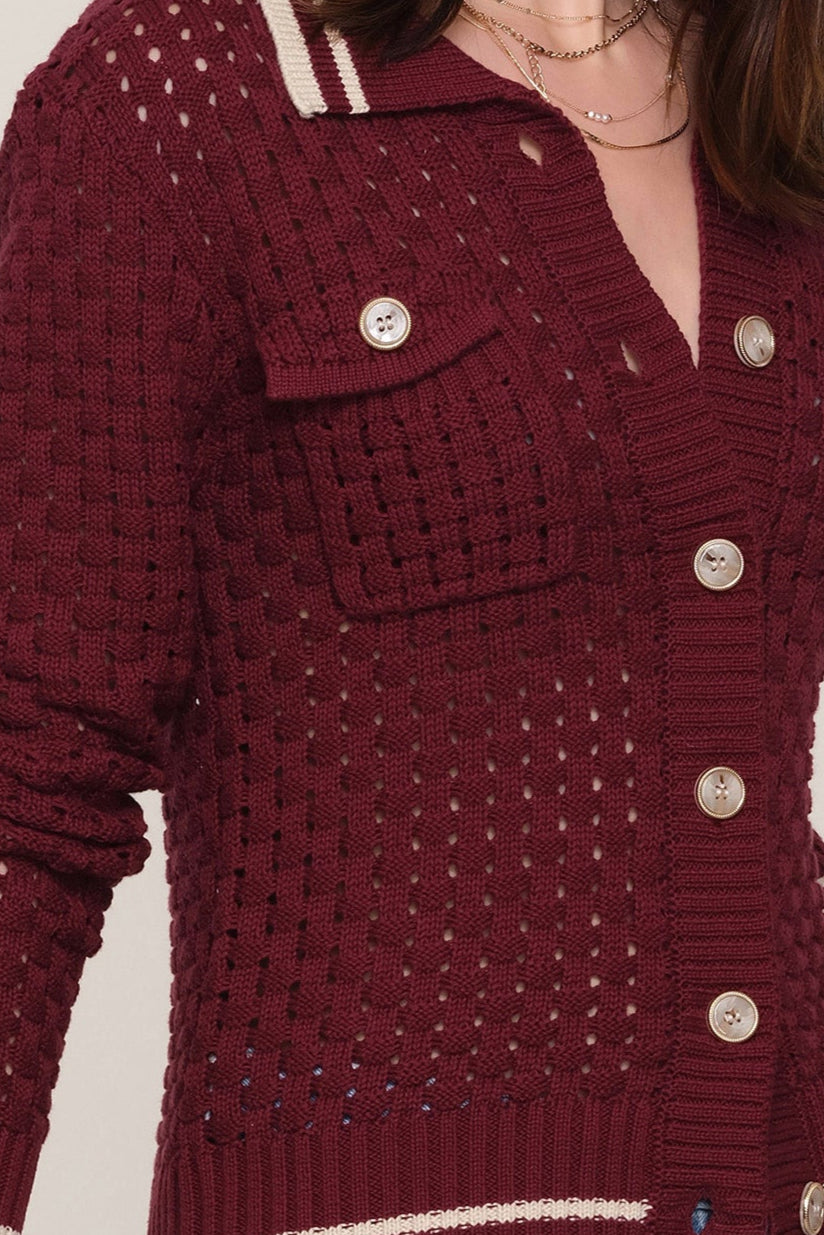 Close-up of a wine open-knit cardigan with buttons 