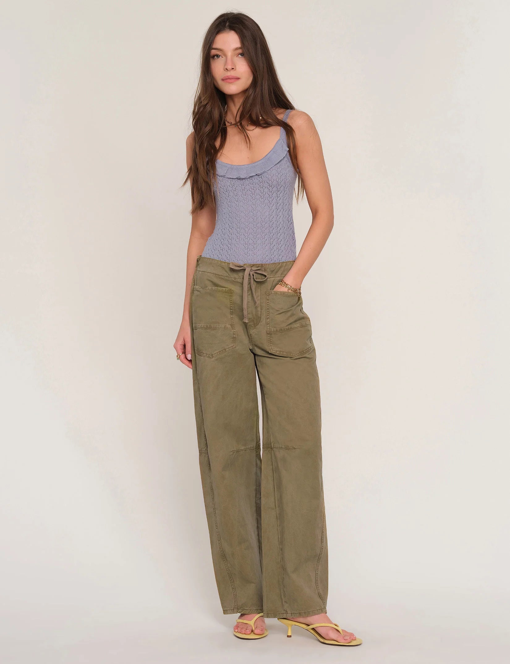 Woman wearing loose fit khaki pants. 