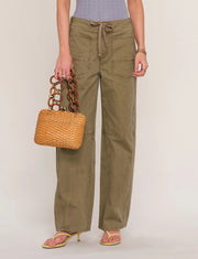 Woman wearing loose fit khaki pants. 