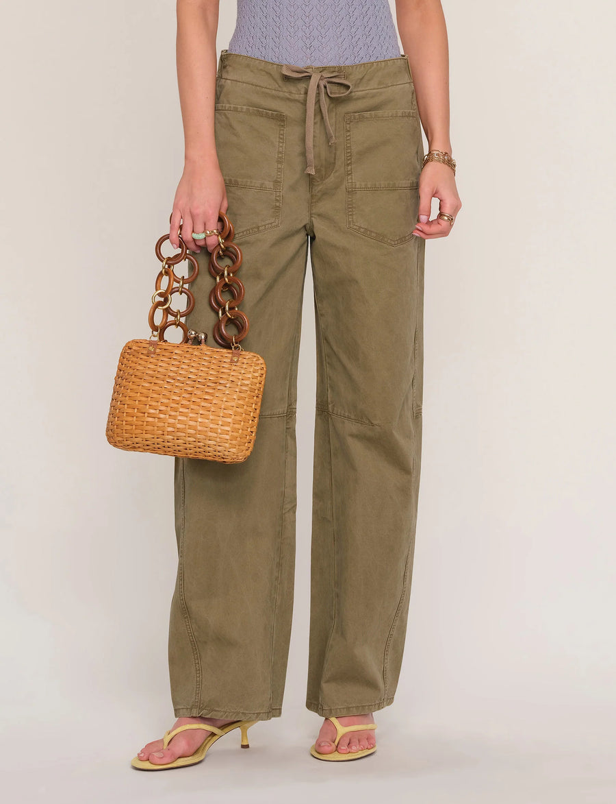 Woman wearing loose fit khaki pants. 
