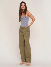 Woman wearing loose fit khaki pants. 