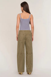 Woman wearing loose fit khaki pants. 