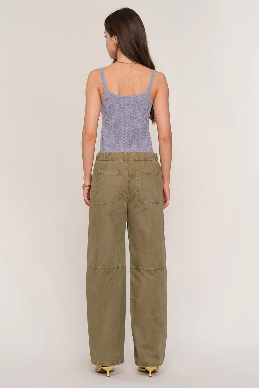 Woman wearing loose fit khaki pants. 
