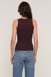 Back facing woman wearing a brown squared neck knitted tank top.