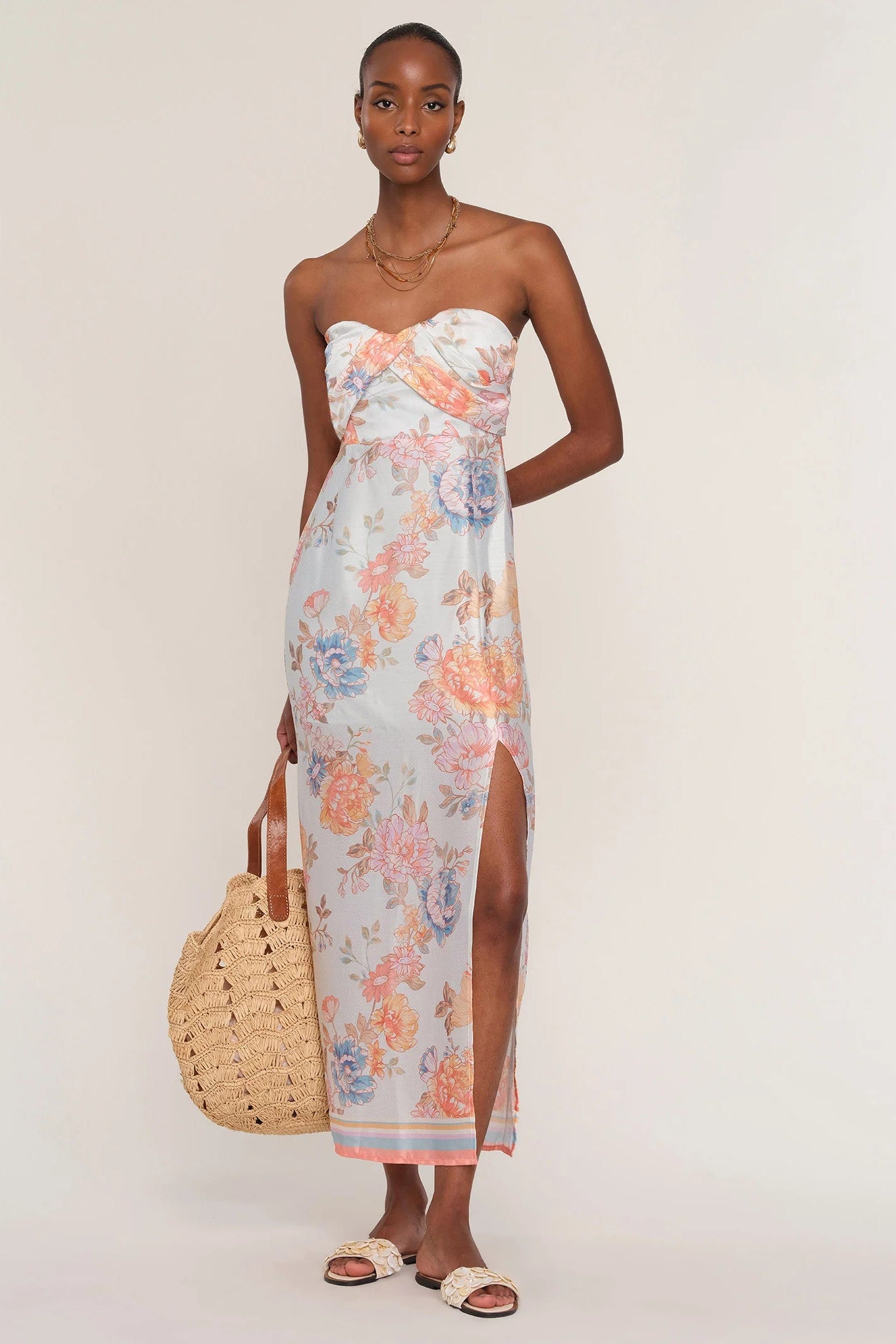 Woman wearing a floral strapless dress. 