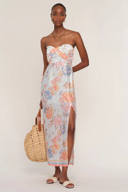 Woman wearing a floral strapless dress. 