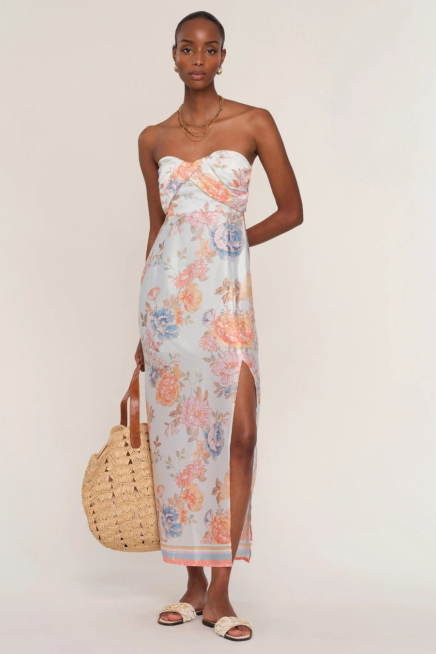 Woman wearing a floral strapless dress. 