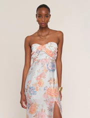 Woman wearing a floral strapless dress. 