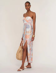 Woman wearing a floral strapless dress. 