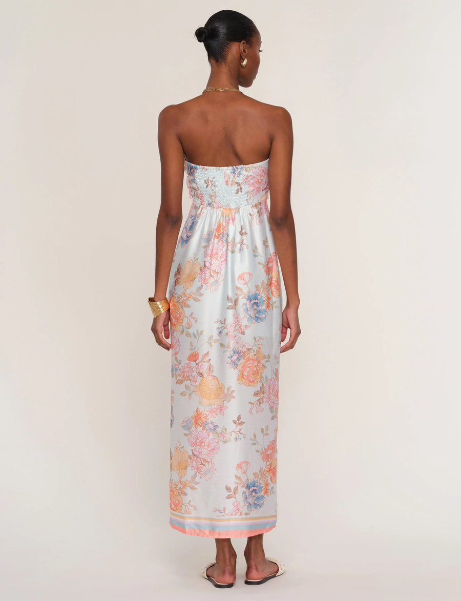 Woman wearing a floral strapless dress. 
